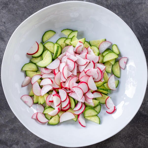 Cucumbers and radish in a bowl.