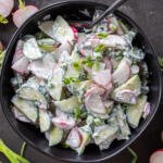 A bowl with Creamy Cucumber Radish Salad.