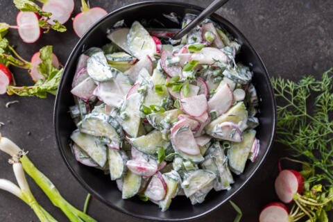 A bowl with Creamy Cucumber Radish Salad.