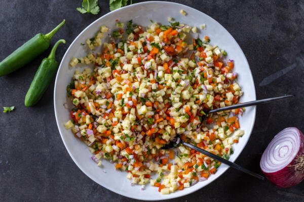 Fresh Pineapple Salsa with serving spoons.