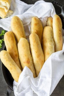 Pan with a towel and Olive Garden Breadsticks.