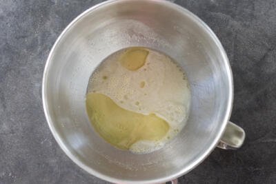 Oil and salt added to the liquids in a mixing bowl.
