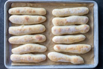 Baking sheet with baked Olive Garden Breadsticks.
