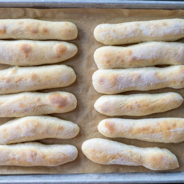 Baking sheet with baked Olive Garden Breadsticks.