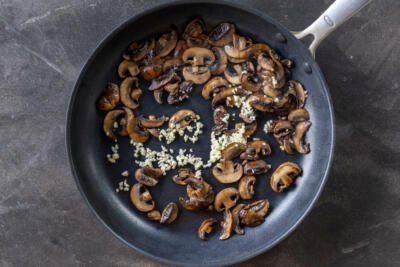 Garlic with mushrooms in a pan.