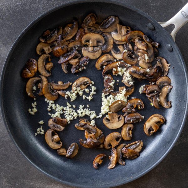 Garlic with mushrooms in a pan.