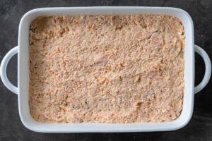 Baking pan with salmon mixture in a pan.