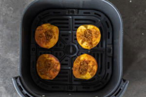 Air fryer baskets with peaches.