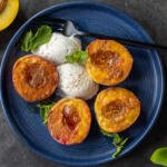 Air Fryer Peaches on a plate with ice cream and mint.