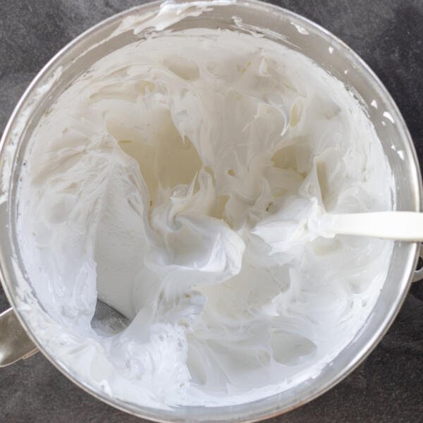 Whisked egg whites in a mixing bowl.
