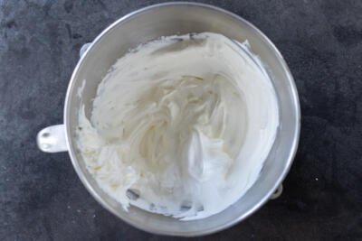 Whisked cream in a mixing bowl.