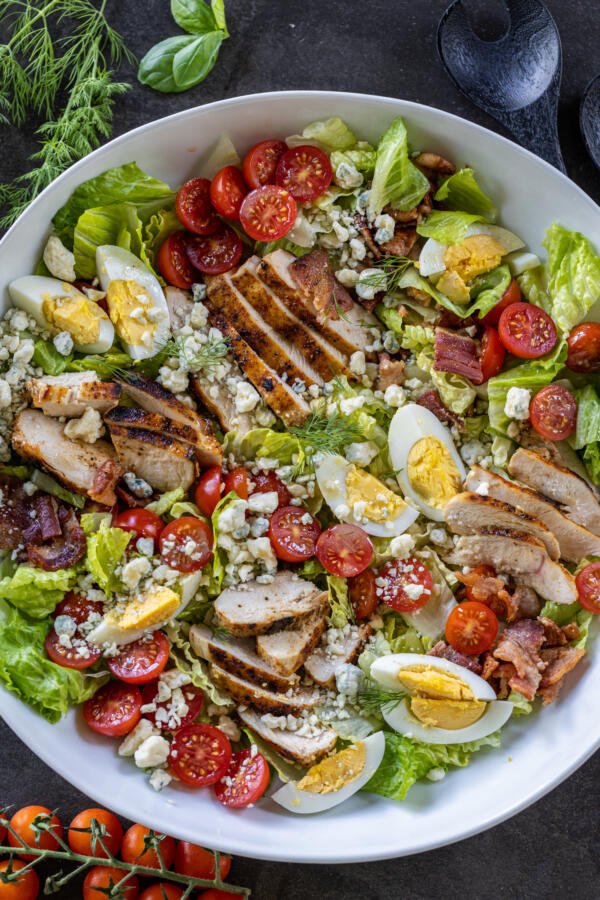 Cobb Salad in a bowl with dressing. 