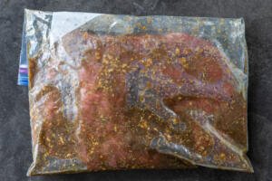 Marinading flank in a ziplock bag.
