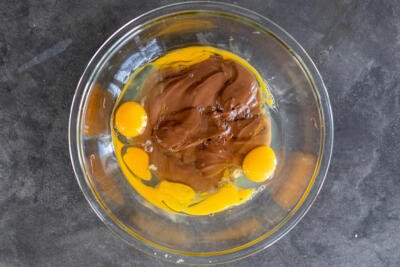 Nutella and eggs in a bowl.