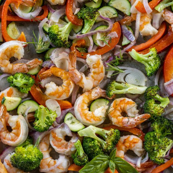 Cooked Shrimp and veggies on a pan.