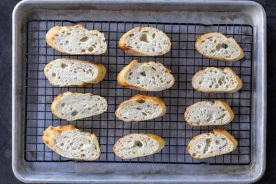 Bread slices on a baking sheet.