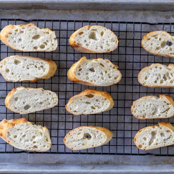 Bread slices on a baking sheet.