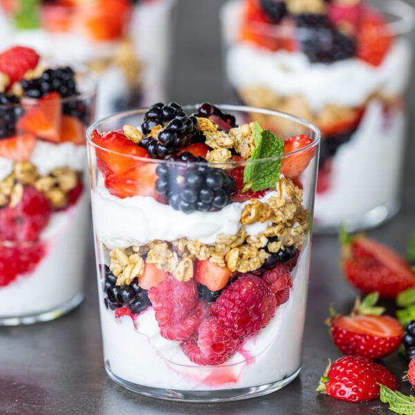 Yogurt Parfaits with berries next to them.