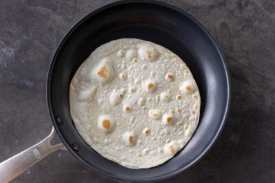 Tortilla cooking on a pan.