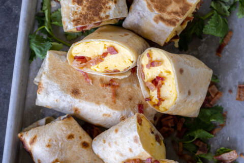 Bacon Egg And Cheese Burrito cut open on a pan.