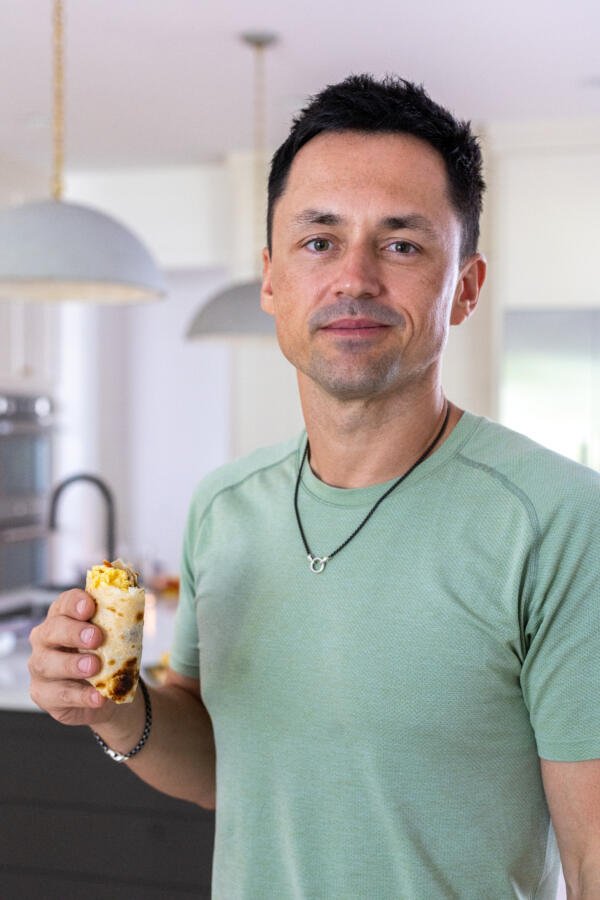 Bacon Egg And Cheese Burrito in Tims hand.