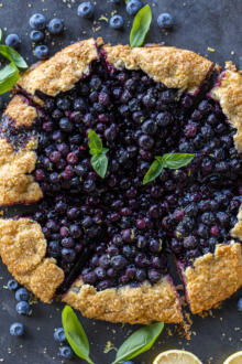 Blueberry Galette sliced with berries and lemon.
