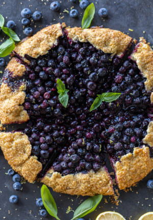 Blueberry Galette sliced with berries and lemon.