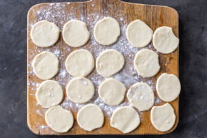 Cut out dough pieces for vareniki.
