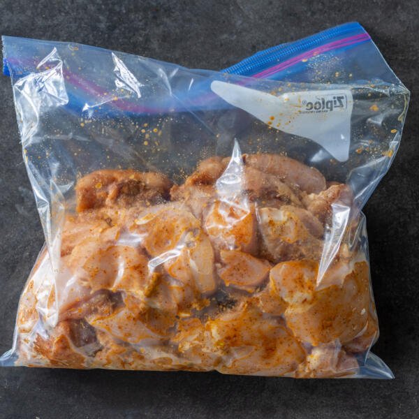 Chicken marinating in a ziplock bag.