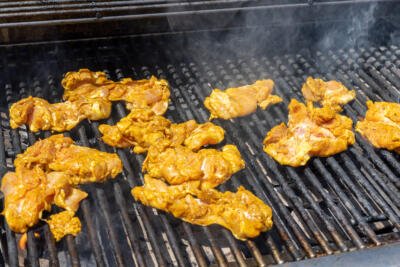 Chicken shawarma on a grill.