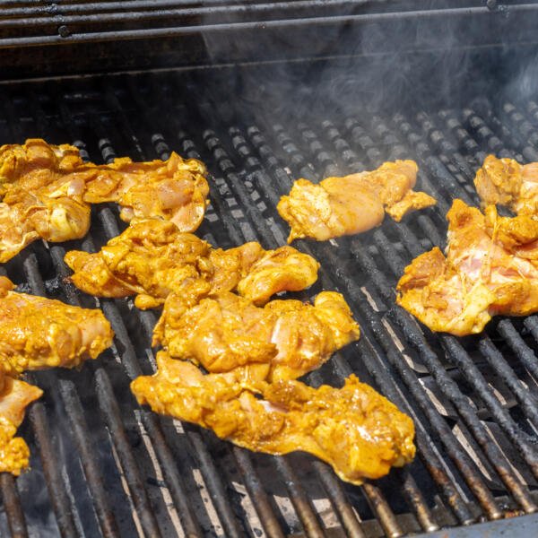 Chicken shawarma on a grill.