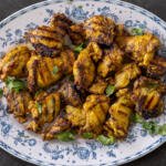 Grilled Chicken Shawarma on a plate with herbs.