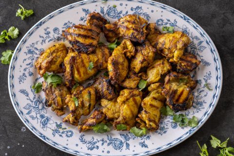 Grilled Chicken Shawarma on a plate with herbs.