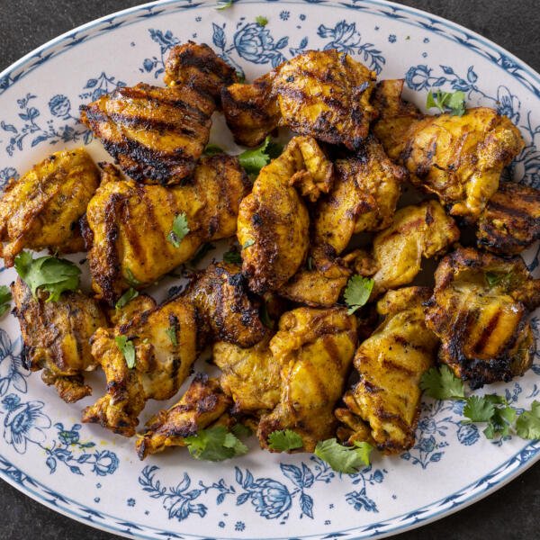 Grilled Chicken Shawarma on a plate with herbs.