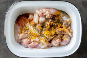 A bow with chicken and all seasoning for shawarma.