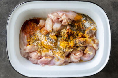 A bow with chicken and all seasoning for shawarma.