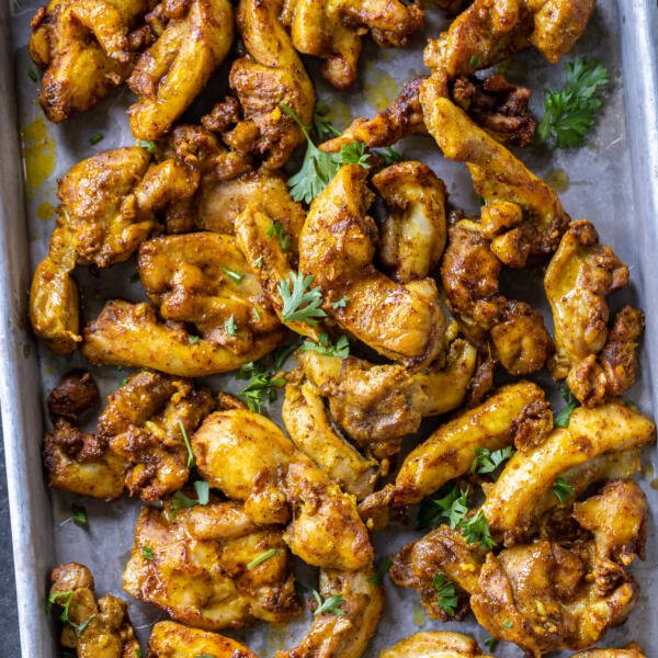 Sheet Pan Chicken Shawarma with herbs on top.