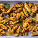 Baking sheet with Sheet Pan Chicken Shawarma.