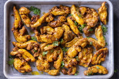 Baking sheet with Sheet Pan Chicken Shawarma.