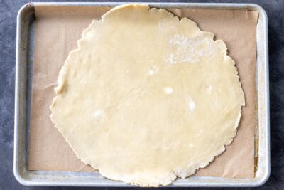 Galette crust dough on a baking sheet.