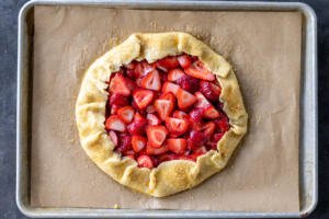 Strawberry Galette on a baking pan with sugar sprinkled.