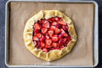 Strawberry Galette on a baking pan with sugar sprinkled.