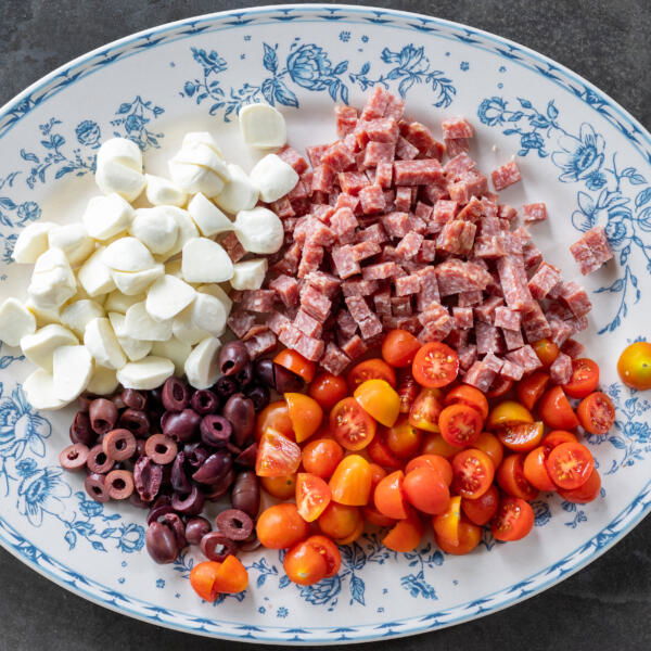 Cut up salami, olives, tomatoes and mozzarella.