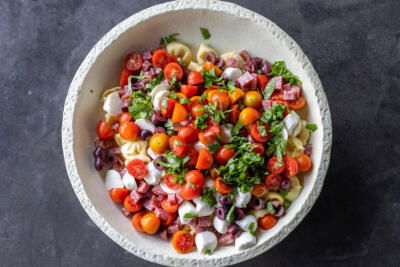 Tortellini Pasta Salad ingredients in a bowl.