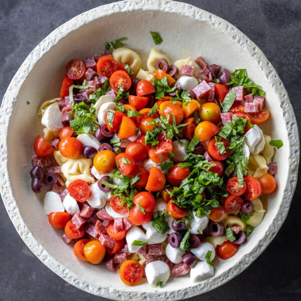 Tortellini Pasta Salad ingredients in a bowl.