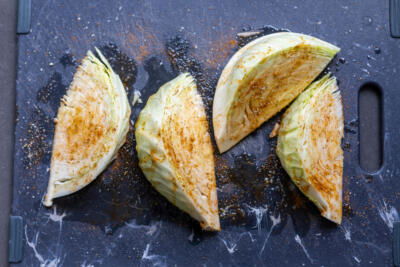 Seasoned cabbage on a cutting board.