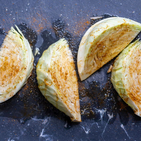 Seasoned cabbage on a cutting board.