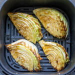 Air fryer Cabbage in an air fryer basket.