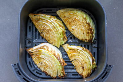 Air fryer Cabbage in an air fryer basket.