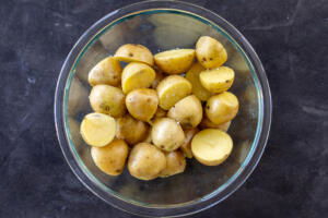 Seasoned sliced potatoes on a bowl.